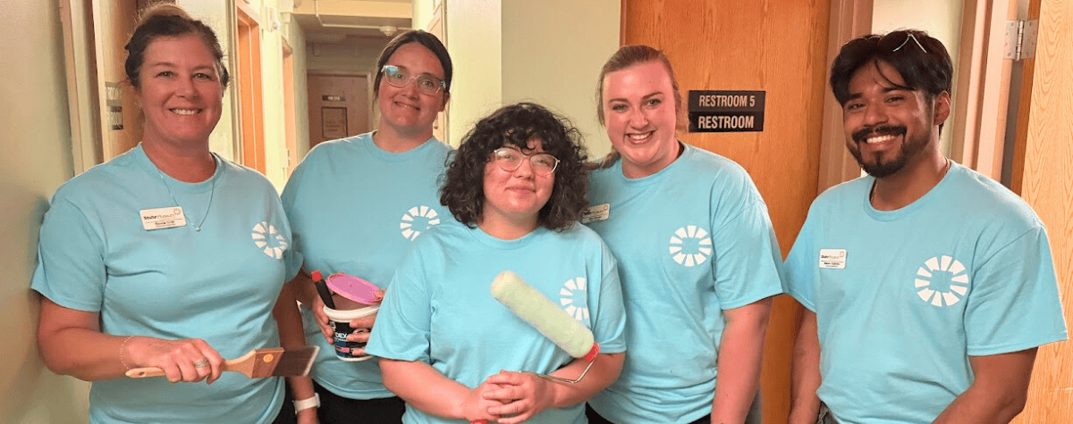 Volunteers paint at Hope Harbor during Day of Action 2025.
