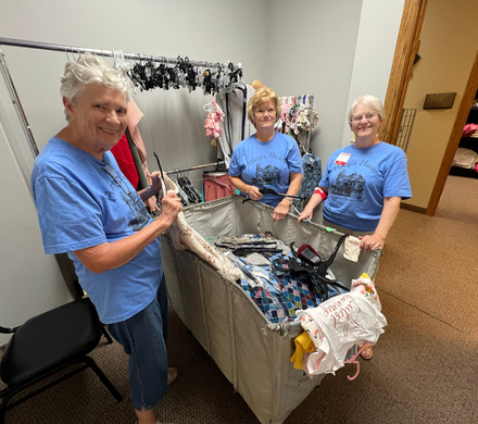 Volunteers sort clothes for Crossroads Mission Avenue during Day of Action 2025.
