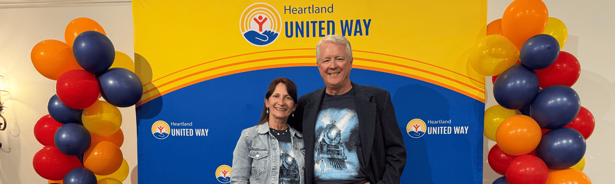 Campaign Chairs Kent and Tonja Brown pose on stage during the Heartland United Way's Annual Meeting