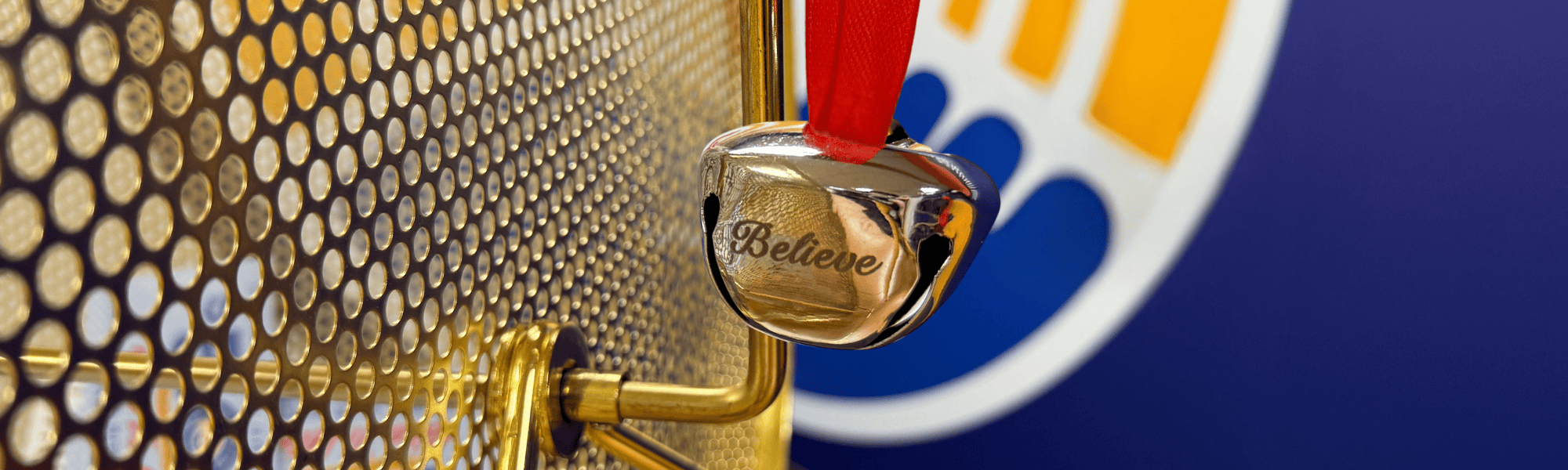 Silver bell hanging from raffle drum