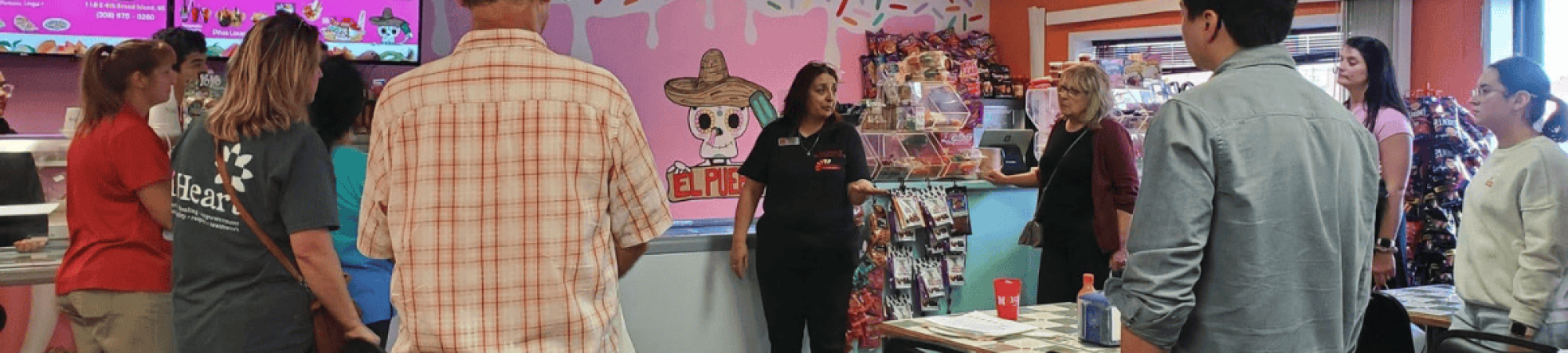 People gather at a restaurant during Welcoming Week 2024.