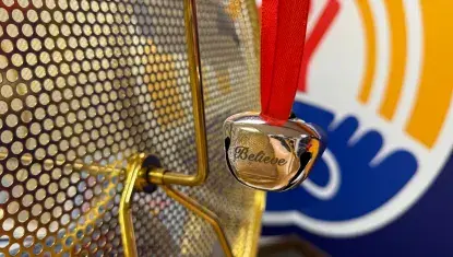 Silver bell hangs on a raffle drum