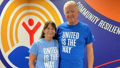 Kent and Tonja Brown wearing shirts that read, United is the Way.